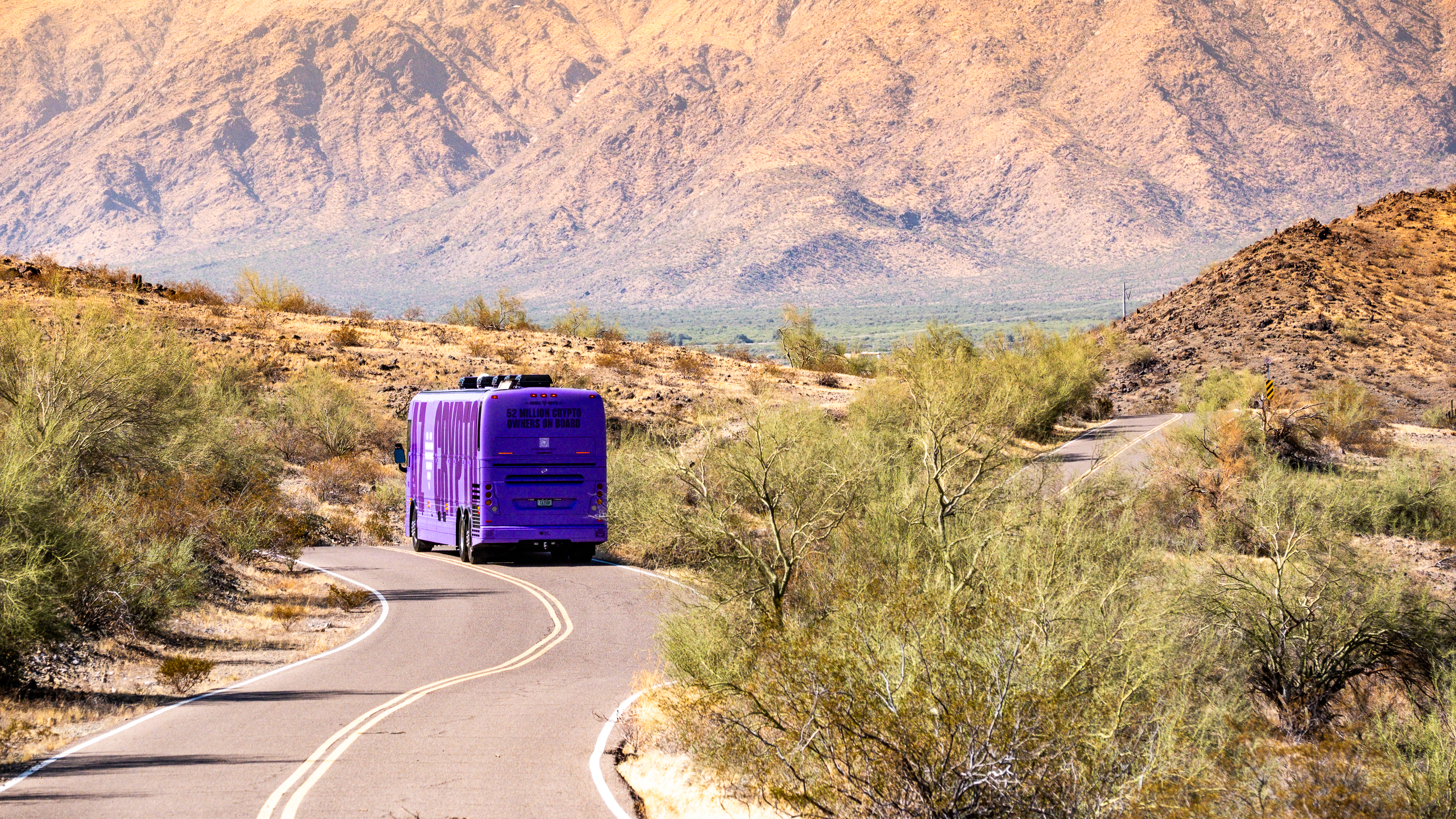 America Loves Crypto bus — desert mountain road
