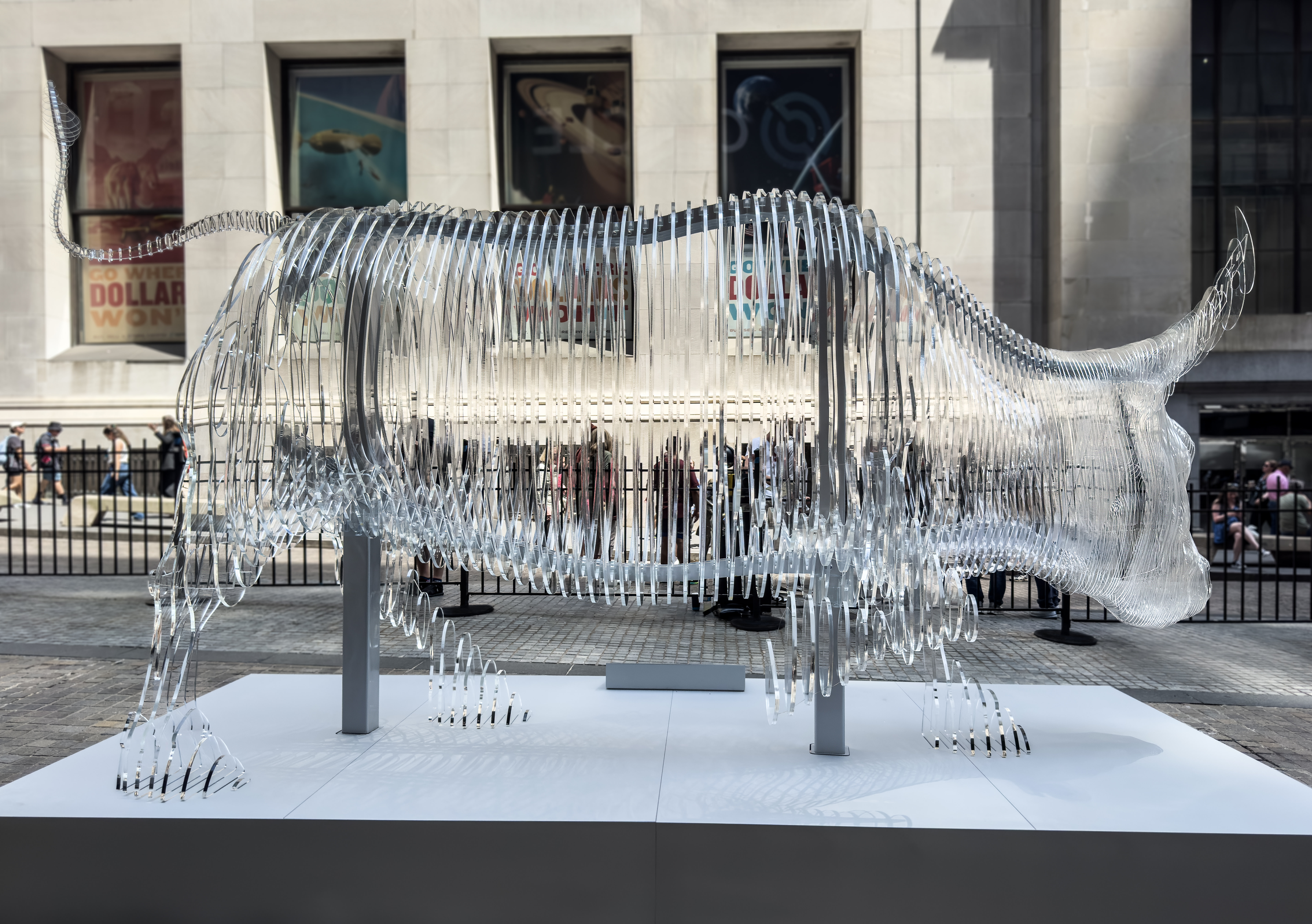 Circle glass bull sculpture side view Wall Street