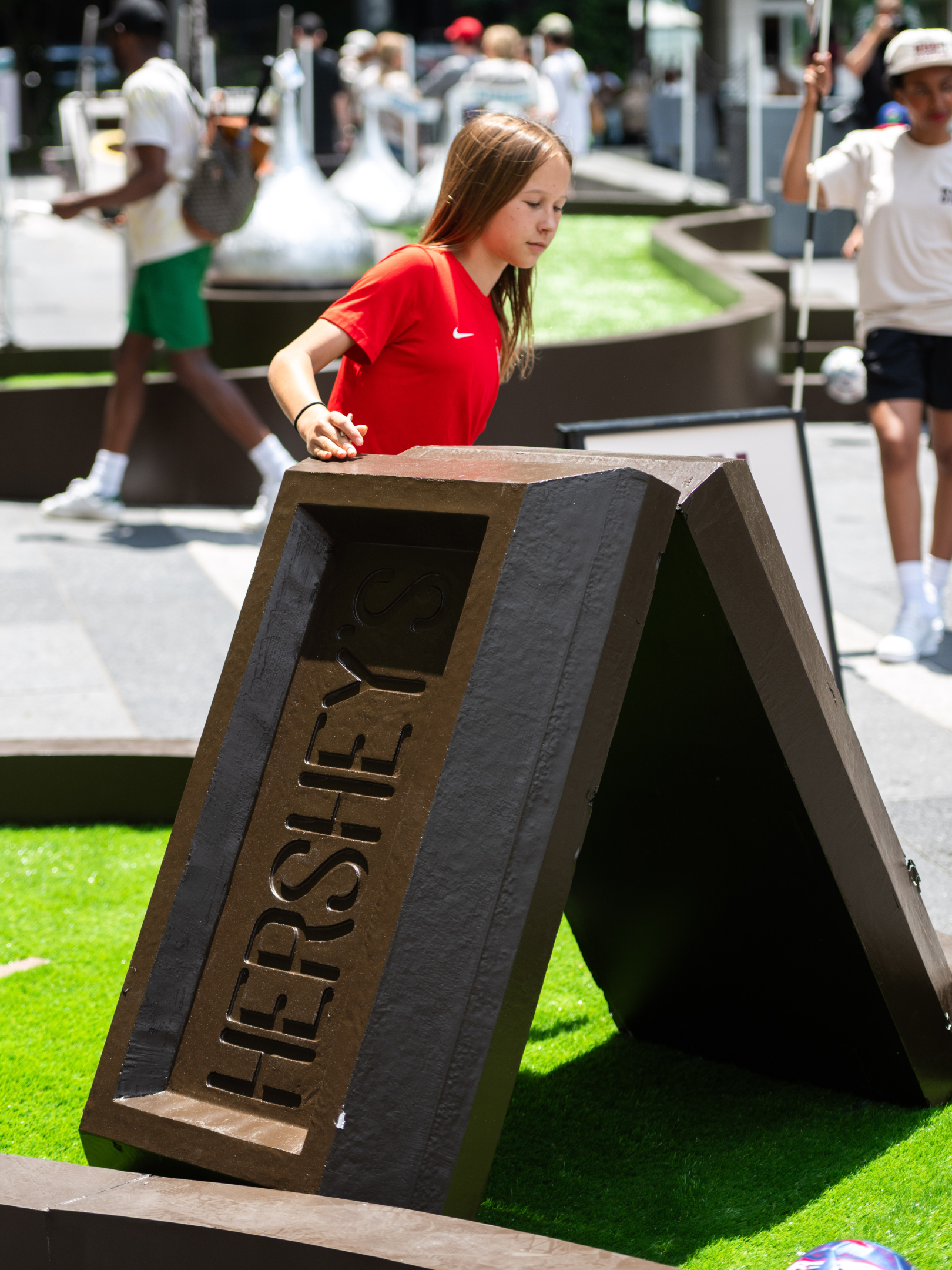 Fan playing the Hershey's bar foot golf obstacle